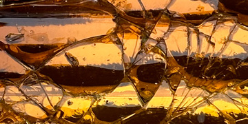 An amber-colored broken glass texture