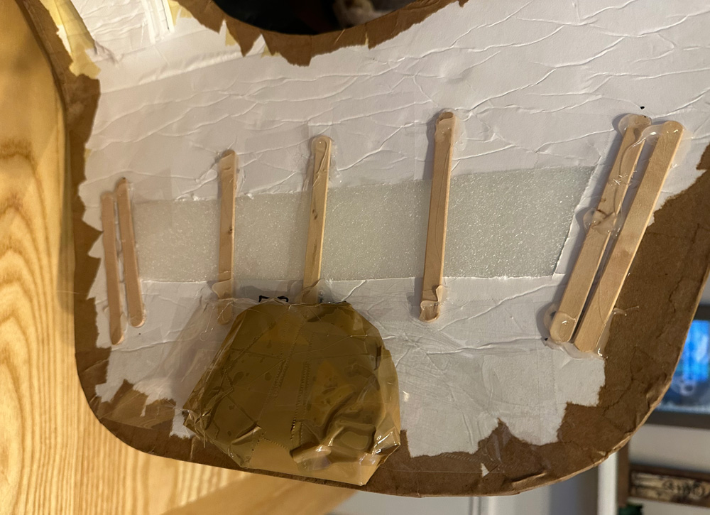 Interior view of the armor, showing the rock taped in place and the wooden supports