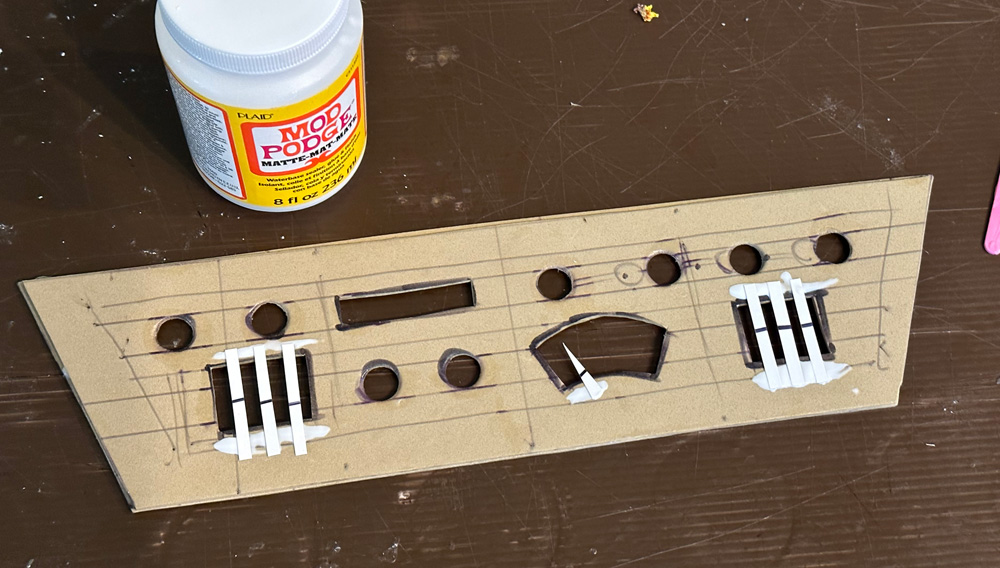 Back view of the chest panel, gluing poster board shapes in place