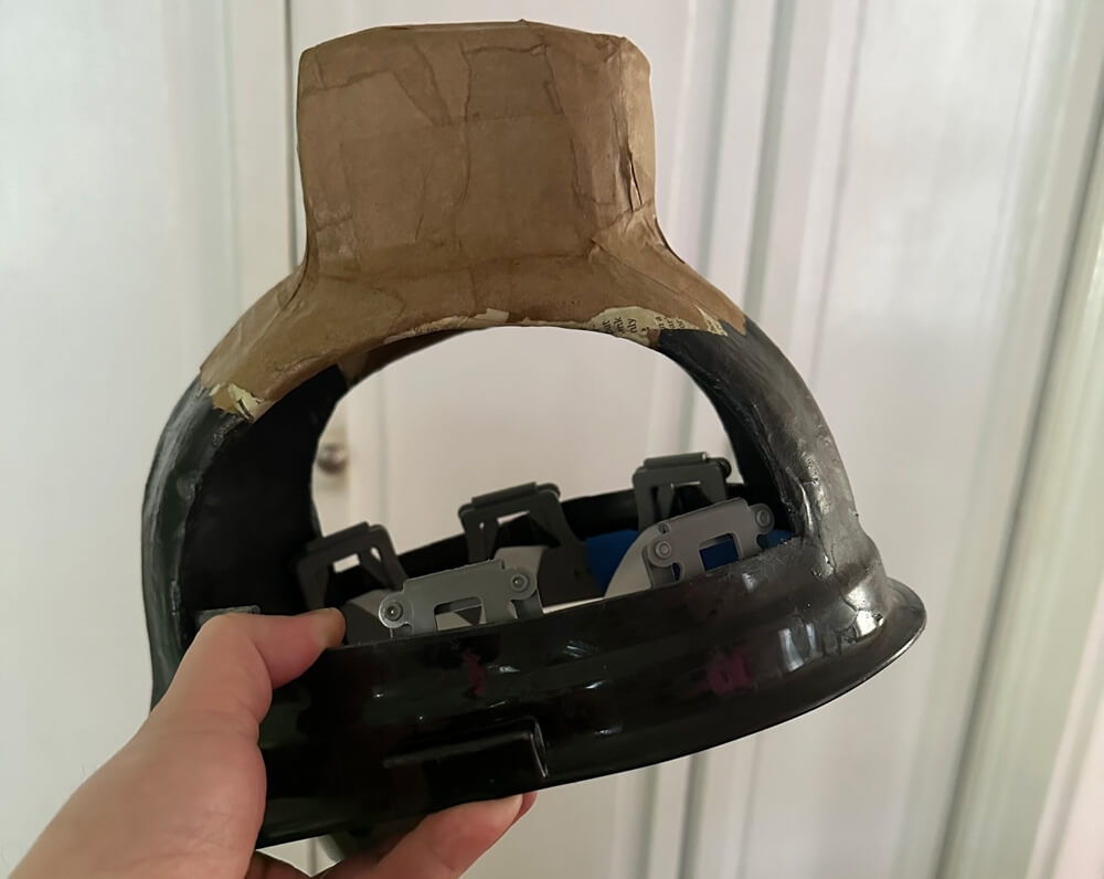 Hard hat with vertical column of foam and paper mache