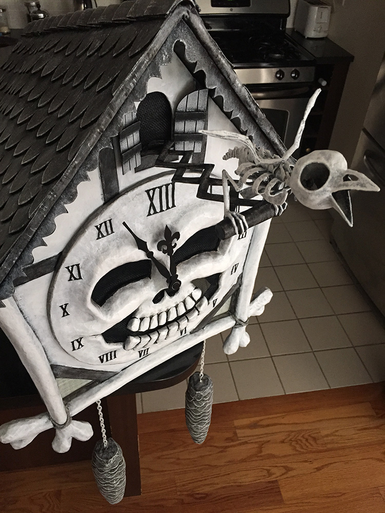 Cuckoo clock skull mask with bird skeleton