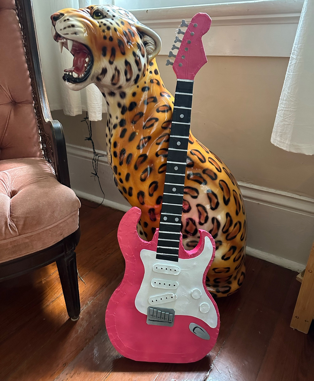 A pink electric guitar; looks pretty real!