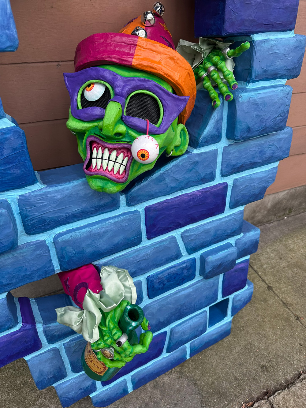 Here I've removed the costume and set the wall down leaning against a real wall, and I've placed the mask down so it's sitting in the large hole at the top of the fake wall; the hands are still in place sticking out of the fake wall.