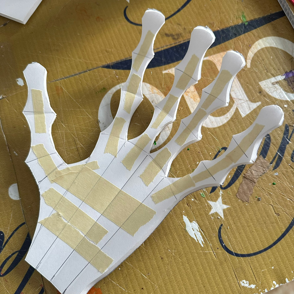 Securing the hand shape in position with tape and hot glue