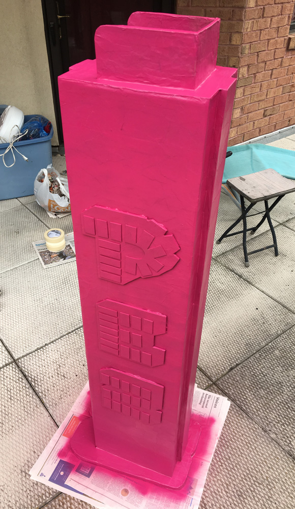 Giant evil clown Pez dispenser - painting the body