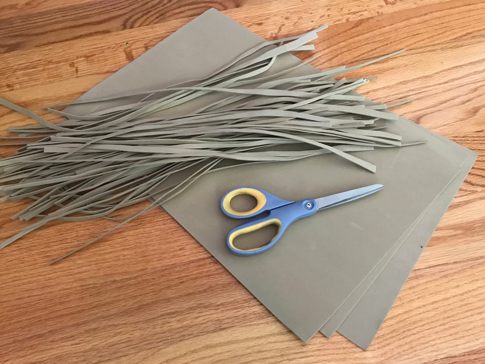 Giant witch statue - cutting craft foam to make the broom bristles