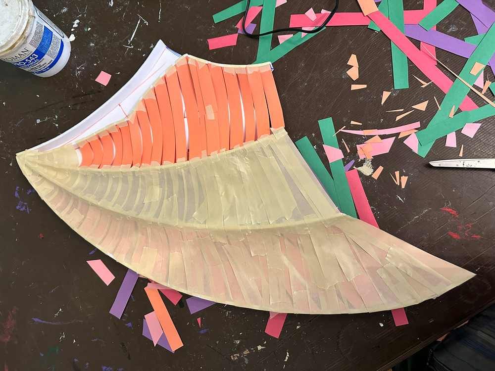 Laying strips of paper into the wings to make the concave shapes