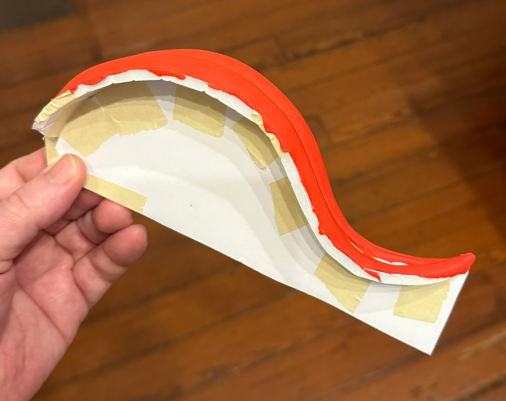 The tongue; a piece of foam board that's mounted on another piece of foam that vaguely looks like a roller coaster track