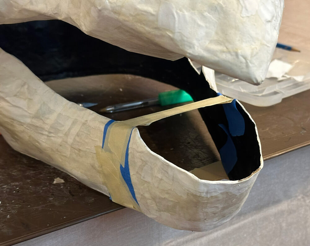 Close up of the gargoyle's lower jaw, cinched with tape