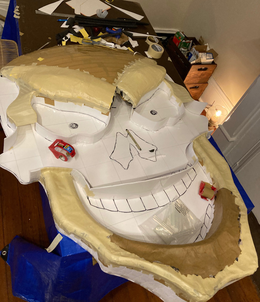 Giant paper mach&eacute; skull Halloween decoration - sculpting the face