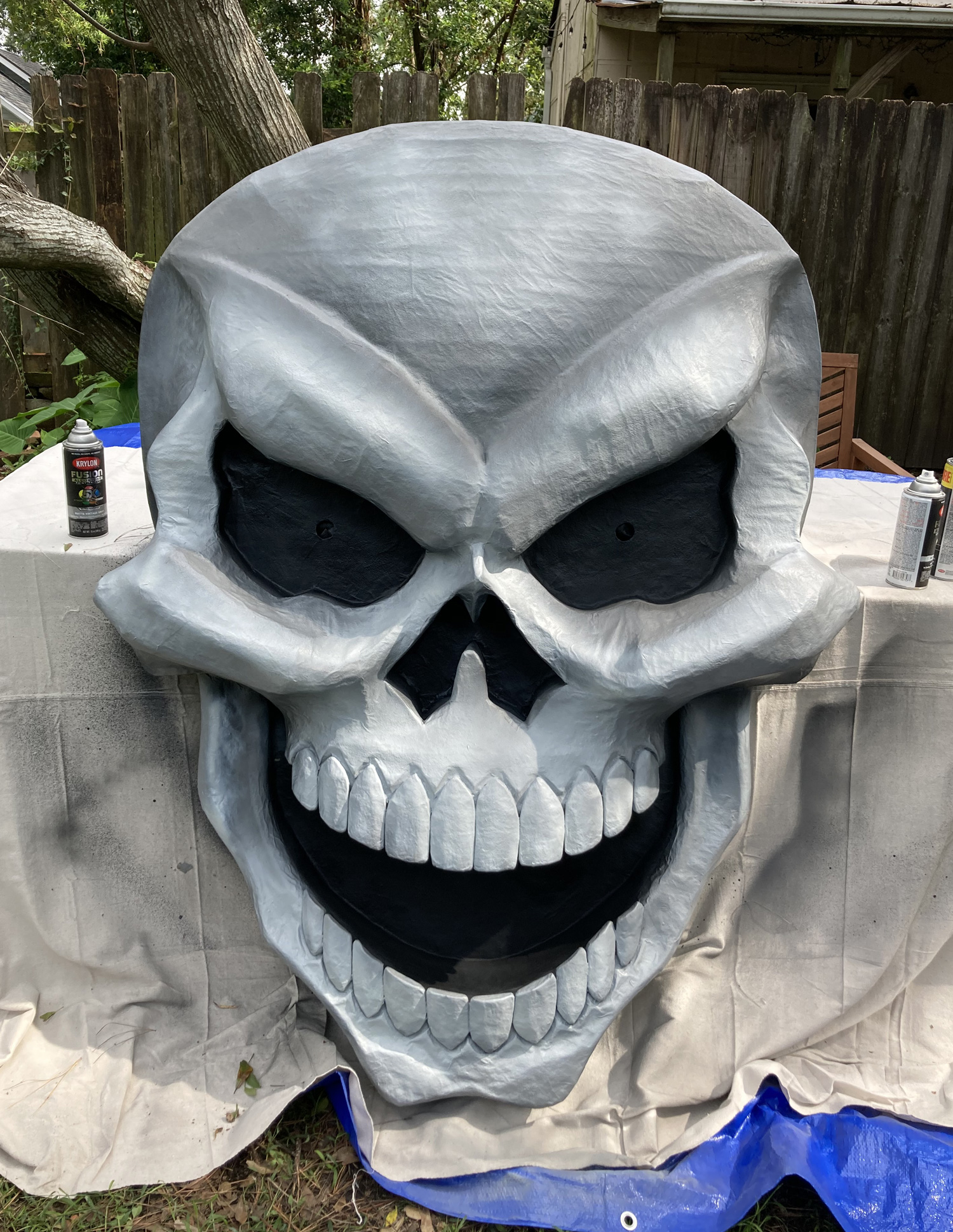 Giant paper mach&eacute; skull Halloween decoration - spray paint