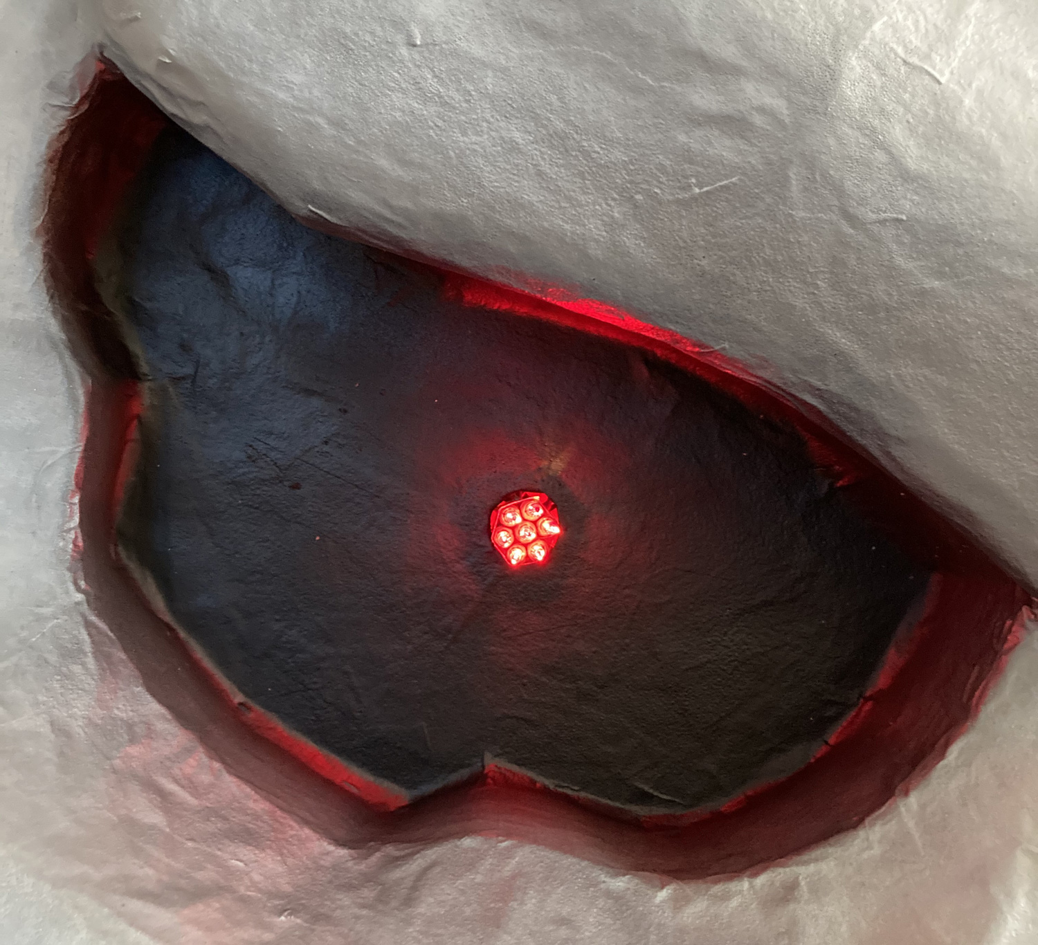 Giant paper mach&eacute; skull Halloween decoration - lights in eyes