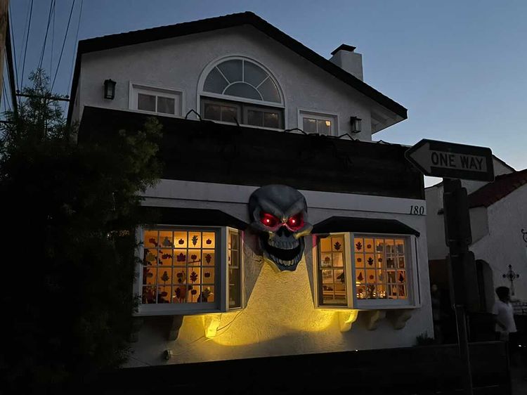 Giant paper mach&eacute; skull Halloween decoration - night time view