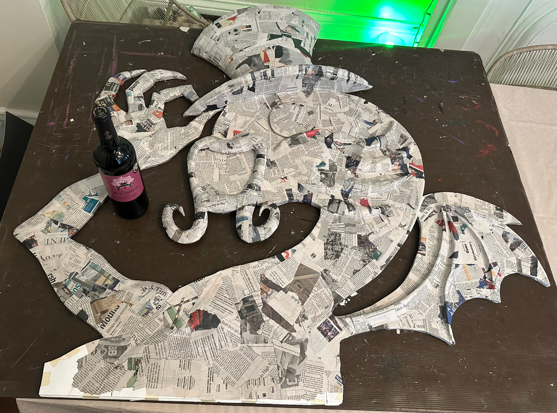 The first component of the Jabberwocky covered in paper mache; a layer of newspaper.