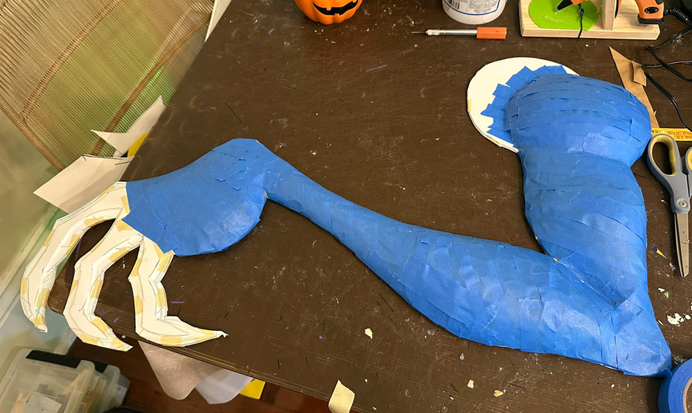 The arm is now covered in blue tape.