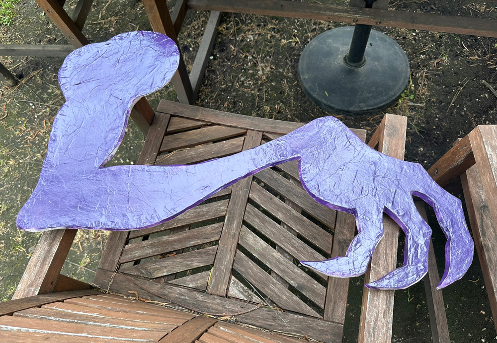 The Jabberwocky's arm, laying upside down with the back surface spray-painted dark purple.