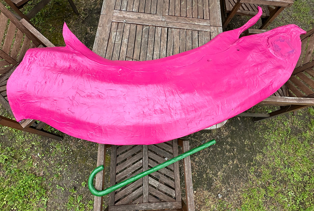 The torso, spray-painted a bright pink/red color.