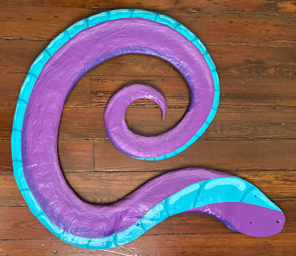 The tail with painting completed; it's purple with a teal underside.