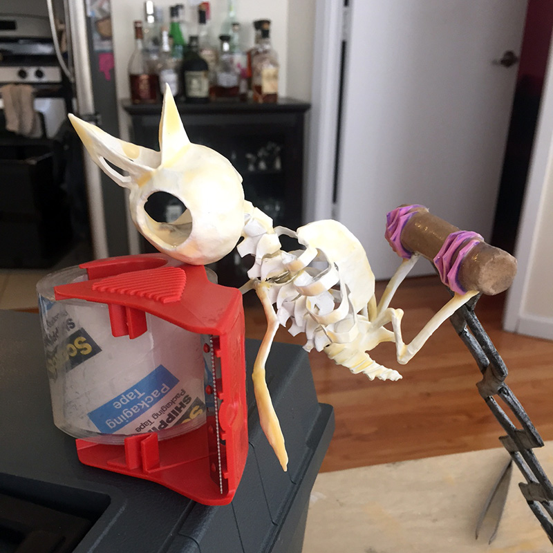 Gluing the bird skull onto the skeleton