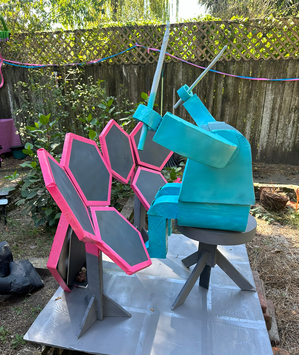Side view of the alien set up in my back yard at his drums, but his head is missing