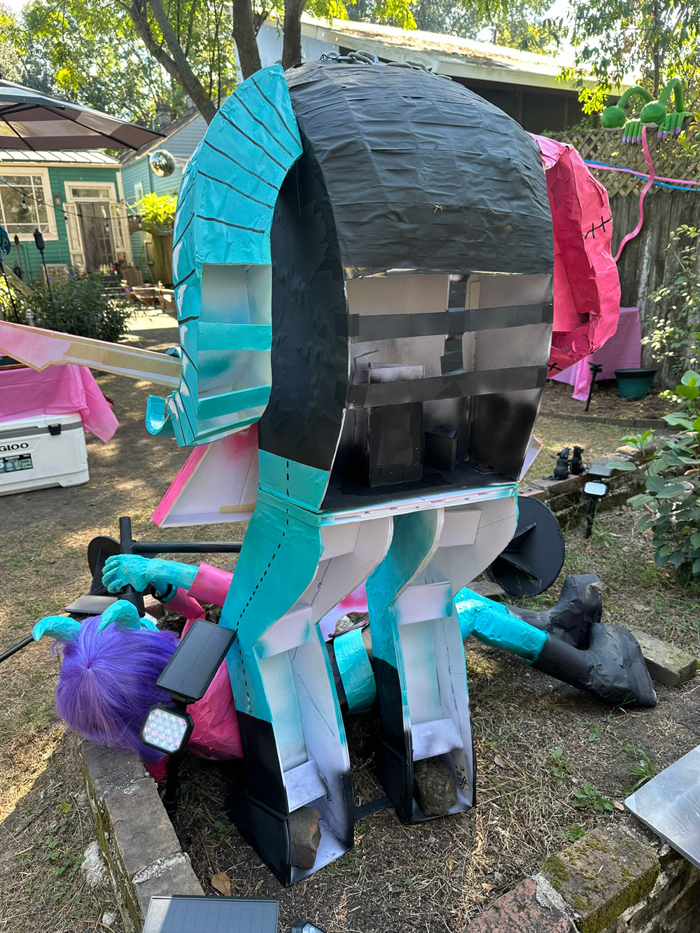 Back view of the Frankenstein statue, showing that the back of his legs and the lower half of his back are completely open and unpainted.
