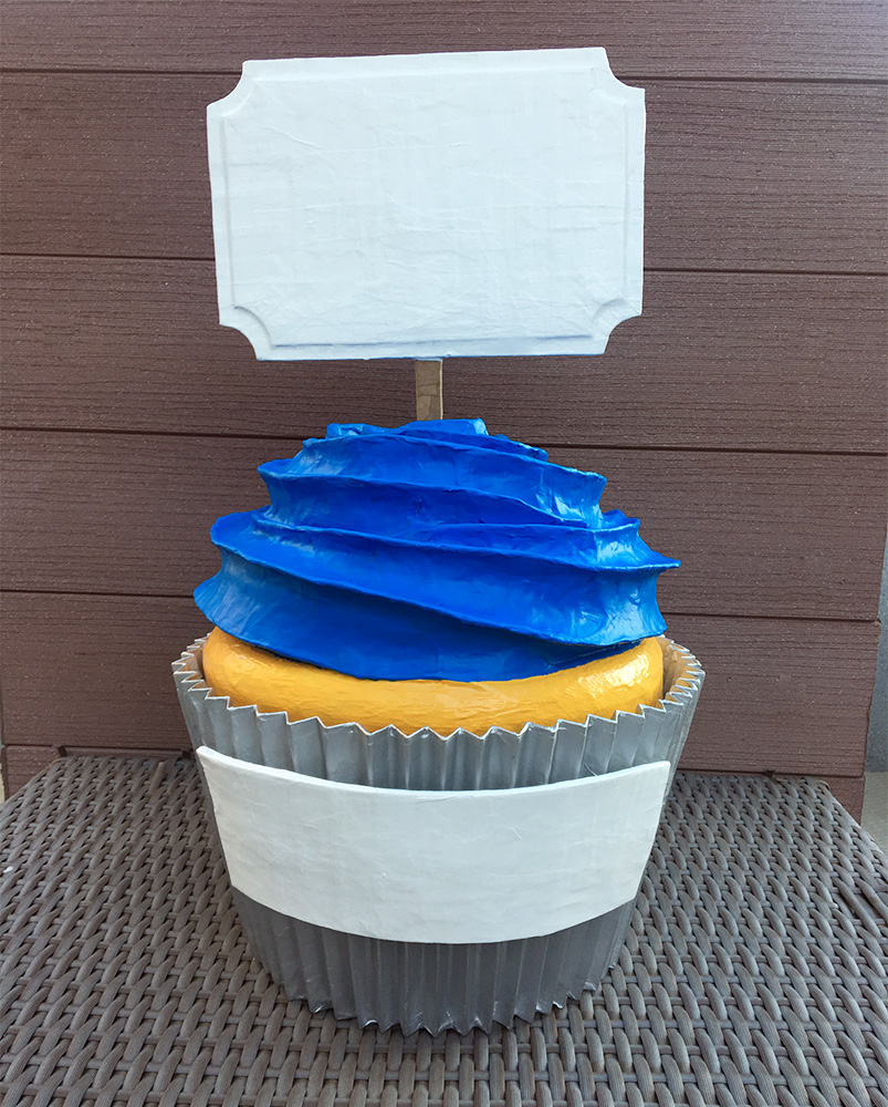 Papier mache cupcake with signs