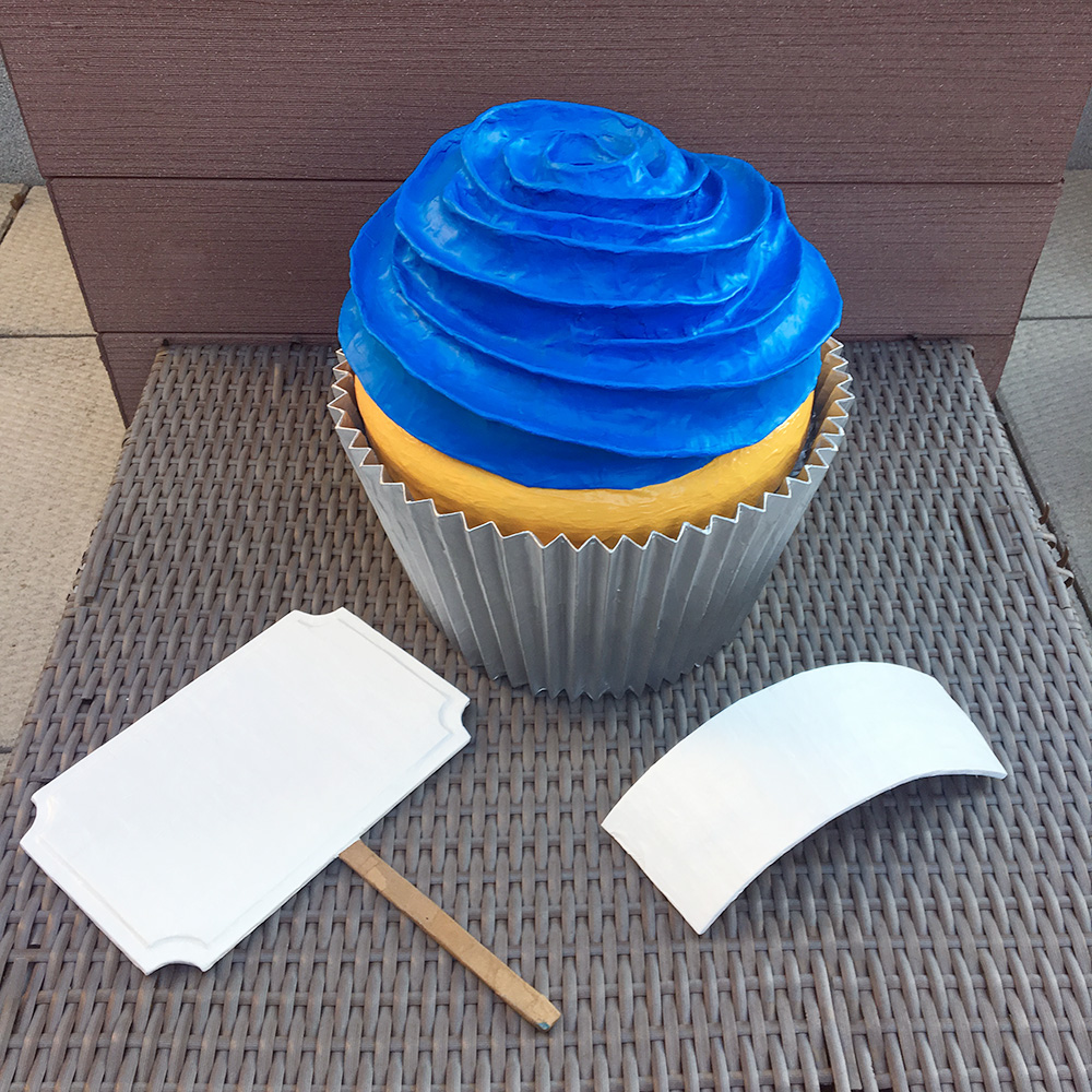 Paper mache cupcake sculpture with blank signs