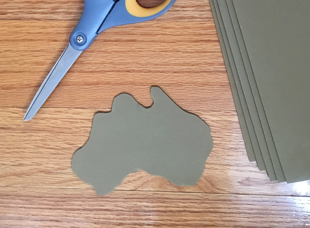 Paper mache globe - cutting out the continents from craft foam