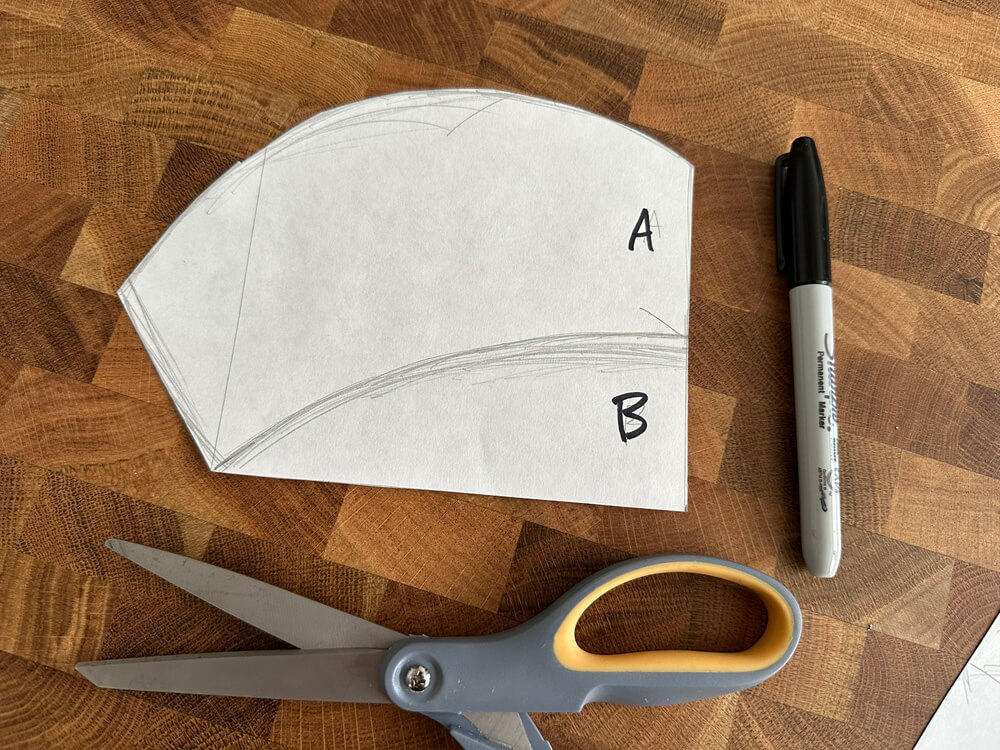 Cutting out the paper pumpkin lid shape