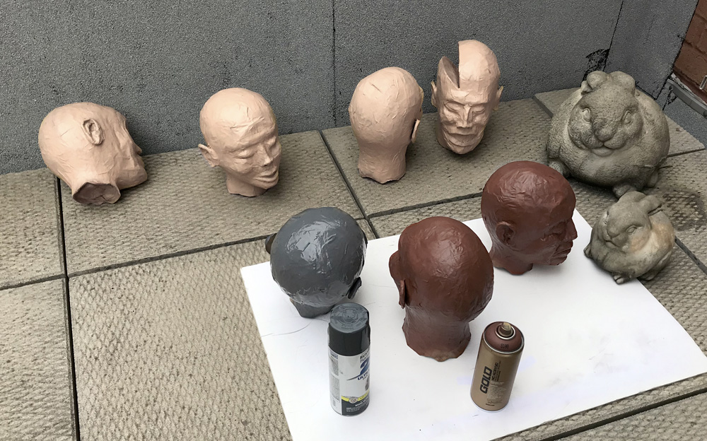 paper mache heads -- spray painting
