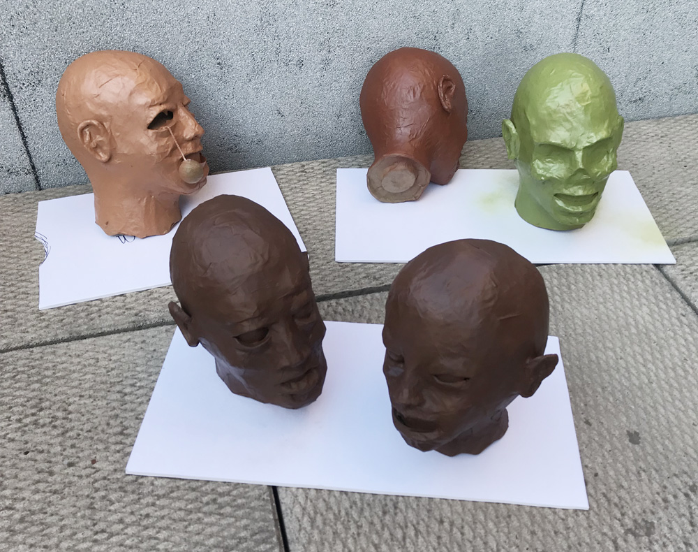 paper mache heads -- spray painting