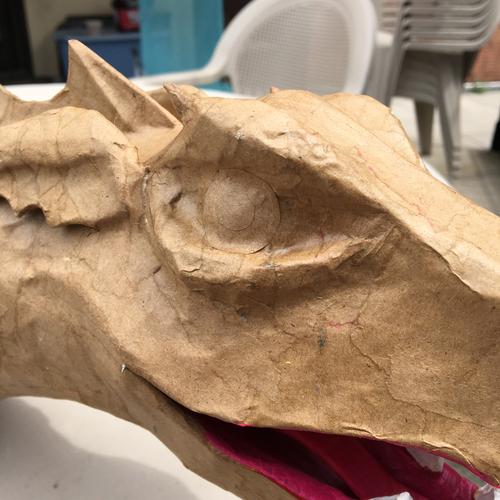 Paper mache three-headed dragon - paper irises and pupils