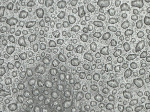 Gray plastic surface with beads of rain.